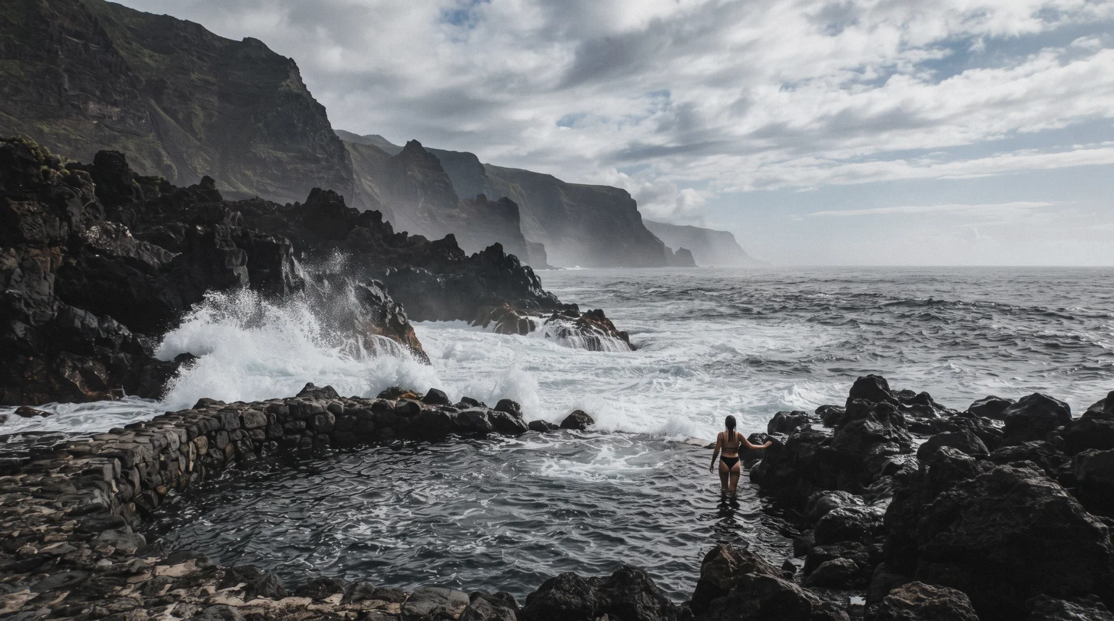 Calmer waters along the coast of the Azores with a whale-watching boat in the distance
