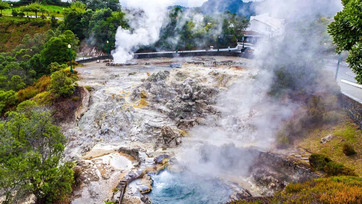 Steam rising from the geothermal fumaroles beside the lake at Furnas, Azores