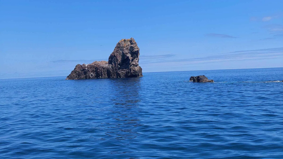 The Monchique Islet alone in blue water off Flores island, the westernmost point of Europe