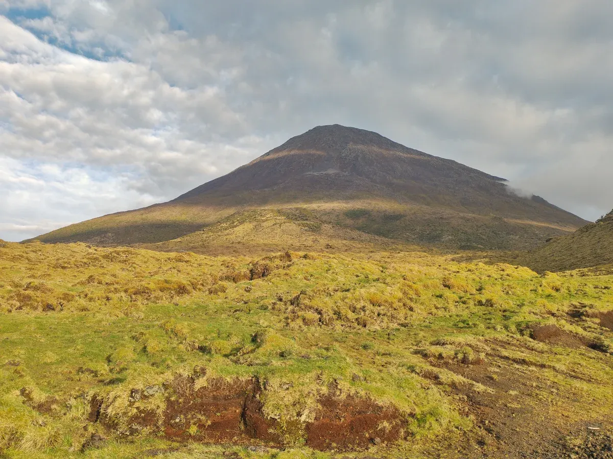 The bare upper cone of Pico mountain in the Azores seen from the lower slopes